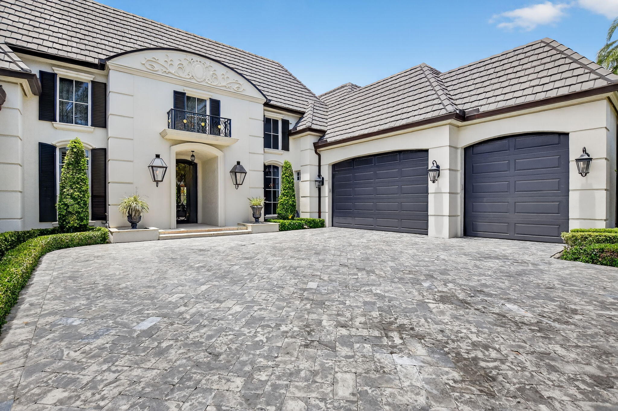 377 East Coconut Palm Road Boca Raton, FL 33432 - Photo 5 of 113 a front view of a house with a yard and garage