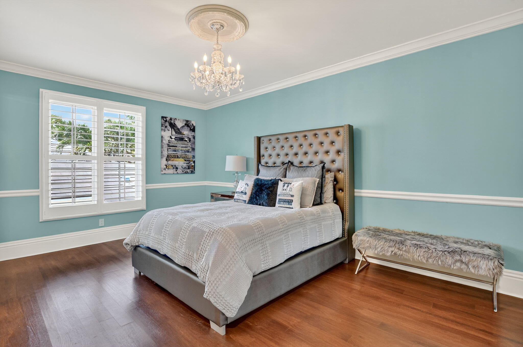 377 East Coconut Palm Road Boca Raton, FL 33432 - Photo 69 of 113 a bedroom with a bed and a chandelier