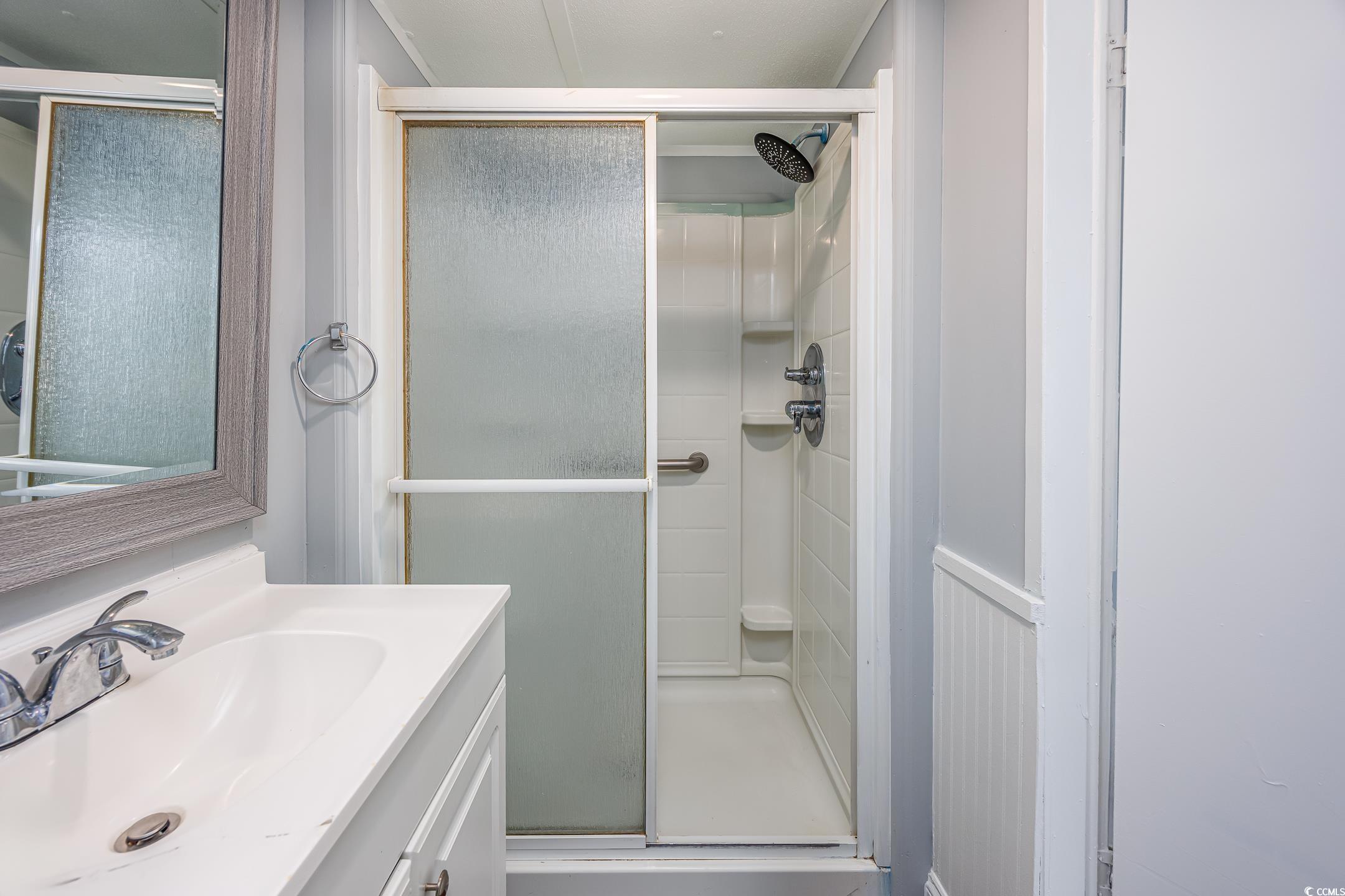 193 Nollie Road Myrtle Beach, SC 29588 - Photo 10 of 35 Full bathroom with a shower stall and vanity