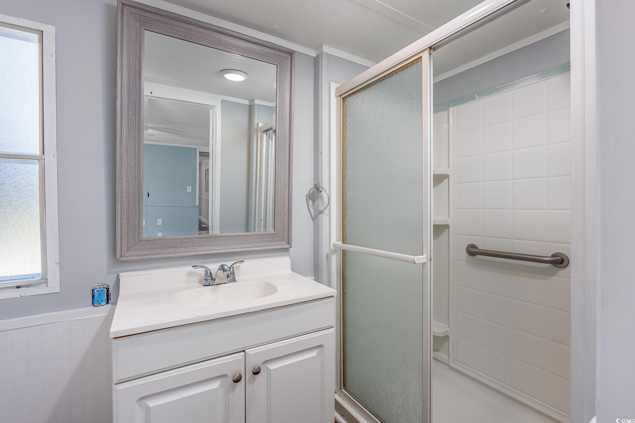193 Nollie Road Myrtle Beach, SC 29588 - Photo 9 of 35 Full bathroom featuring a stall shower and vanity