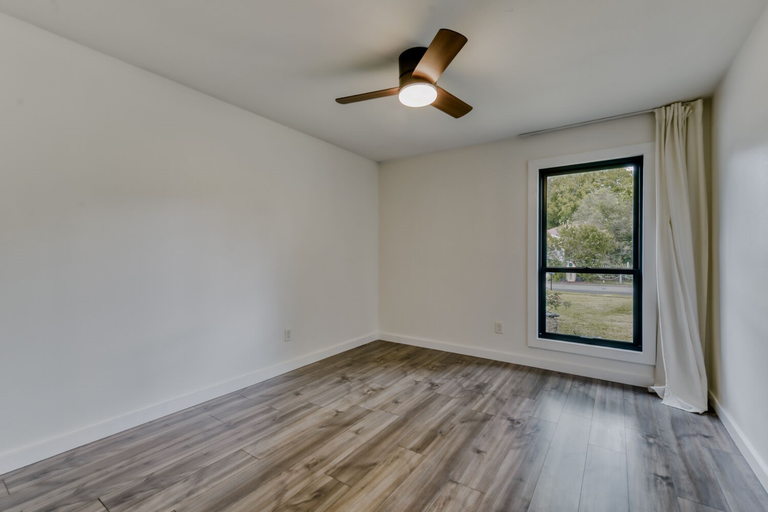 6108 Bridlington Circle Austin, TX 78745 - Photo 15 of 22 a view of empty room with wooden floor and fan