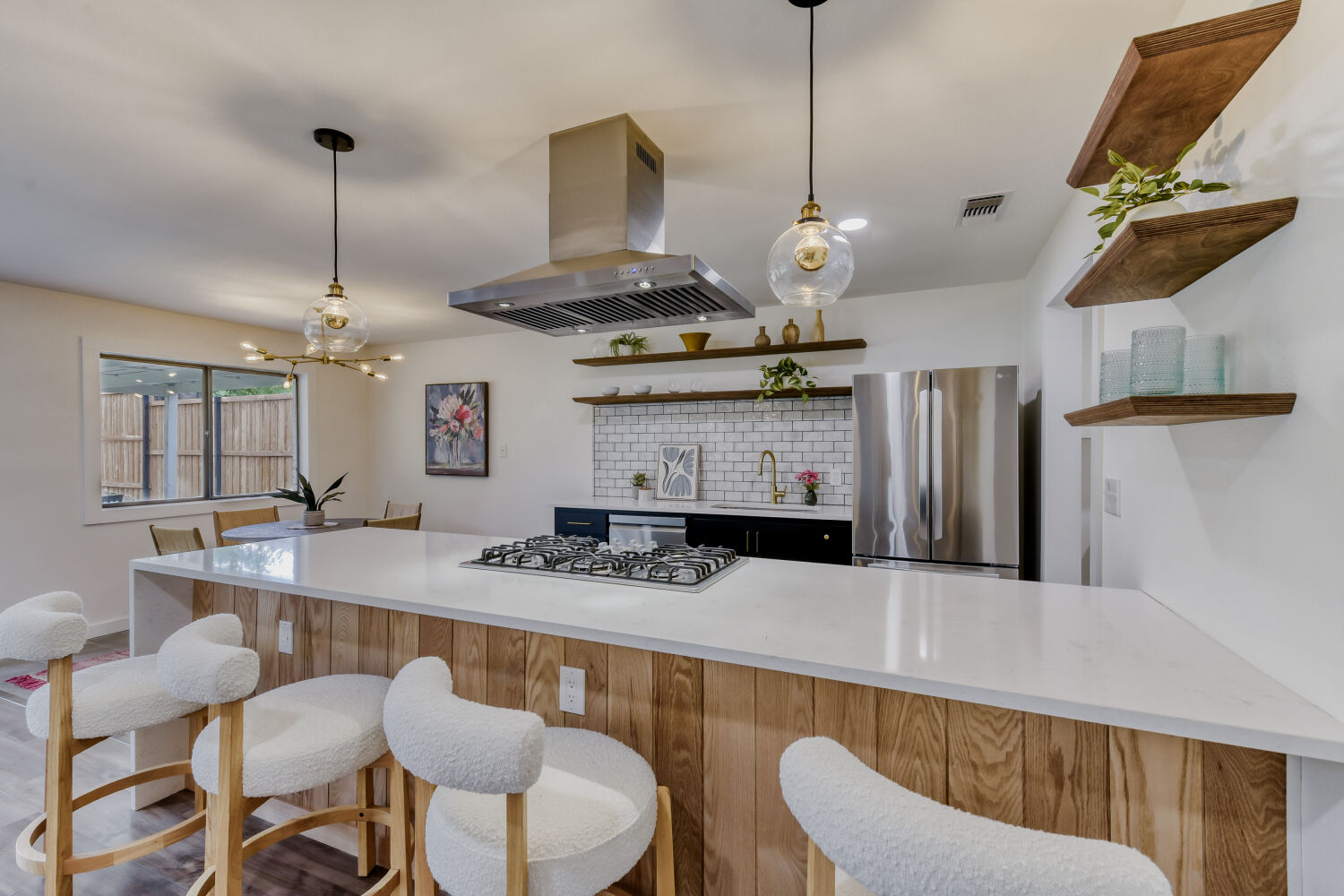 6108 Bridlington Circle Austin, TX 78745 - Photo 6 of 22 a kitchen with stainless steel appliances granite countertop a sink a stove a dining table and chairs