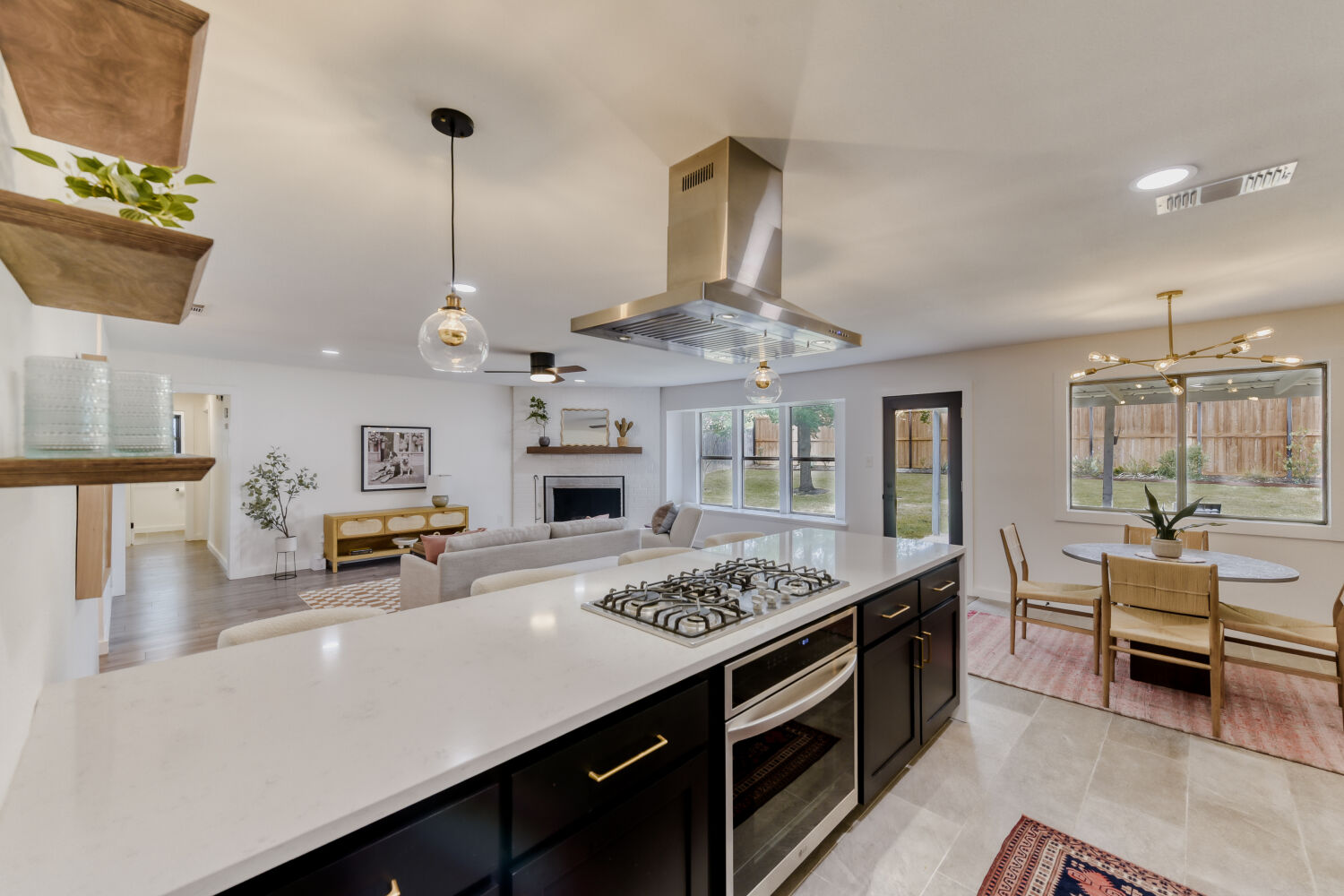 6108 Bridlington Circle Austin, TX 78745 - Photo 8 of 22 a kitchen with a stove a chandelier and a view of living room