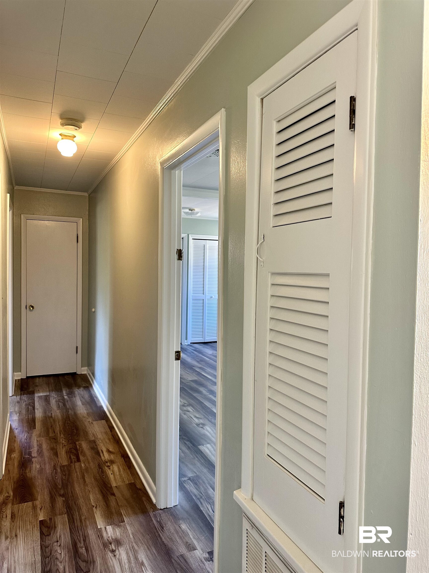 103 Avalon Street Brewton, AL 36426 - Photo 9 of 14 Corridor with dark hardwood / wood-style floors and ornamental molding