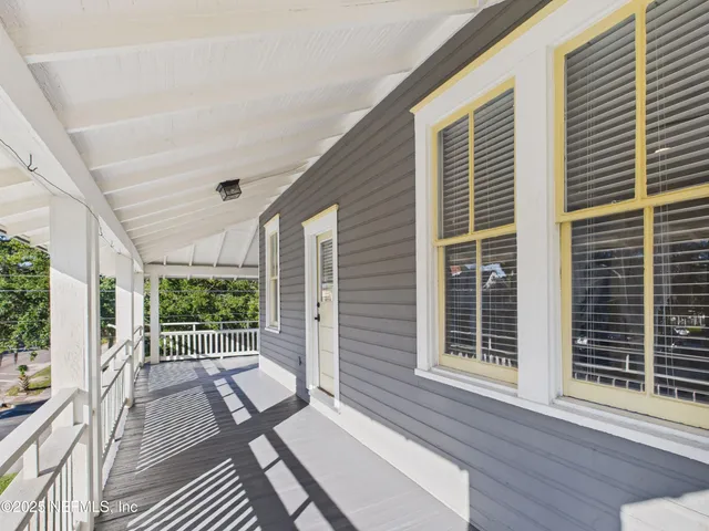a view of a balcony with wooden floor