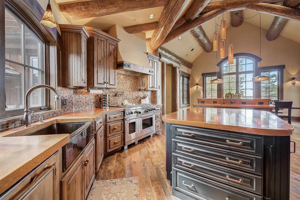 350 Timbertrail Road Breckenridge, CO 80424 - Photo 11 of 35 a kitchen with stainless steel appliances granite countertop a sink a stove and a wooden floors