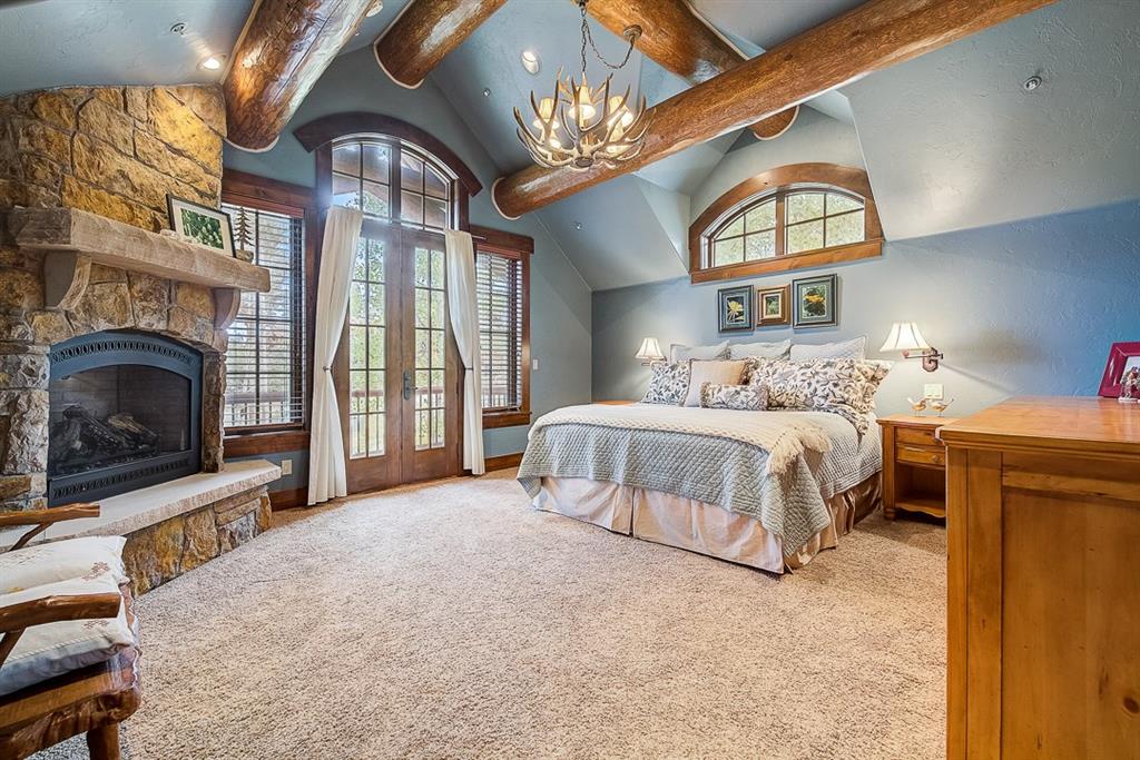 350 Timbertrail Road Breckenridge, CO 80424 - Photo 13 of 35 a bedroom with a bed and a fireplace