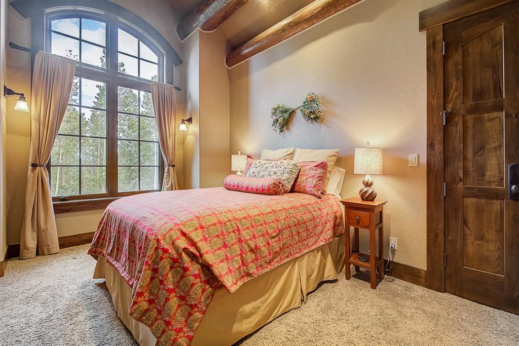 350 Timbertrail Road Breckenridge, CO 80424 - Photo 16 of 35 a bed sitting in a bedroom next to a window