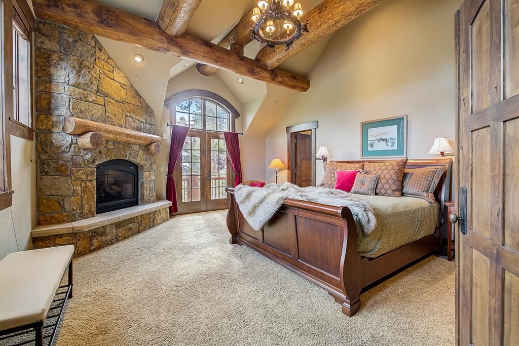 350 Timbertrail Road Breckenridge, CO 80424 - Photo 18 of 35 a spacious bedroom with a bed and a fireplace
