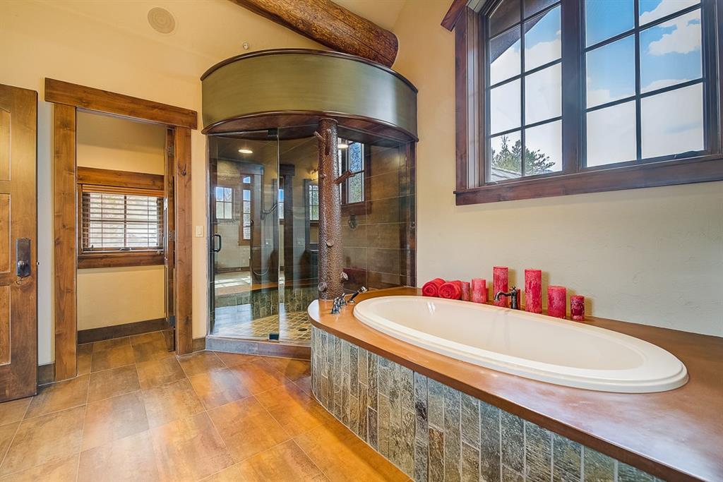 350 Timbertrail Road Breckenridge, CO 80424 - Photo 21 of 35 a bathroom with a bathtub a shower and a sink