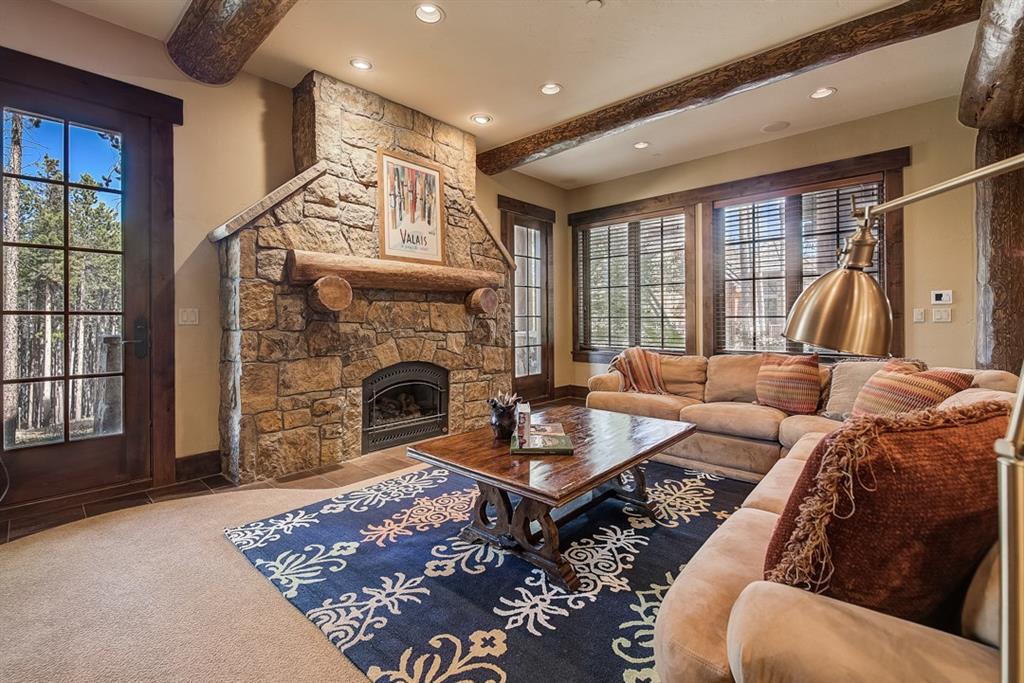 350 Timbertrail Road Breckenridge, CO 80424 - Photo 25 of 35 a living room with furniture a rug and a fireplace