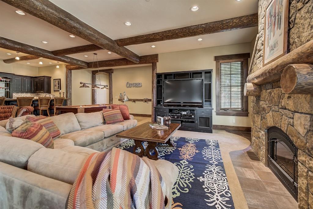 350 Timbertrail Road Breckenridge, CO 80424 - Photo 26 of 35 a living room with furniture a fireplace and a flat screen tv