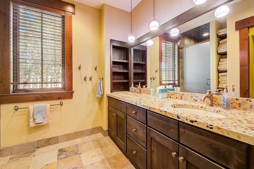 350 Timbertrail Road Breckenridge, CO 80424 - Photo 28 of 35 a bathroom with a granite countertop sink and a large mirror