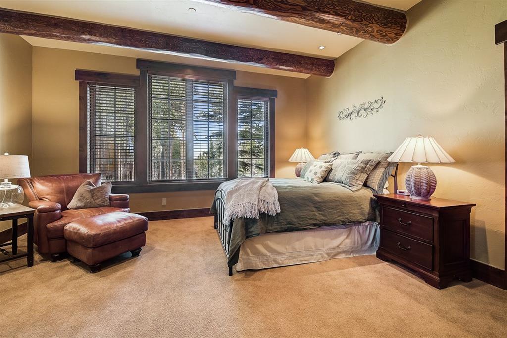 350 Timbertrail Road Breckenridge, CO 80424 - Photo 29 of 35 a spacious bedroom with a bed and glass window