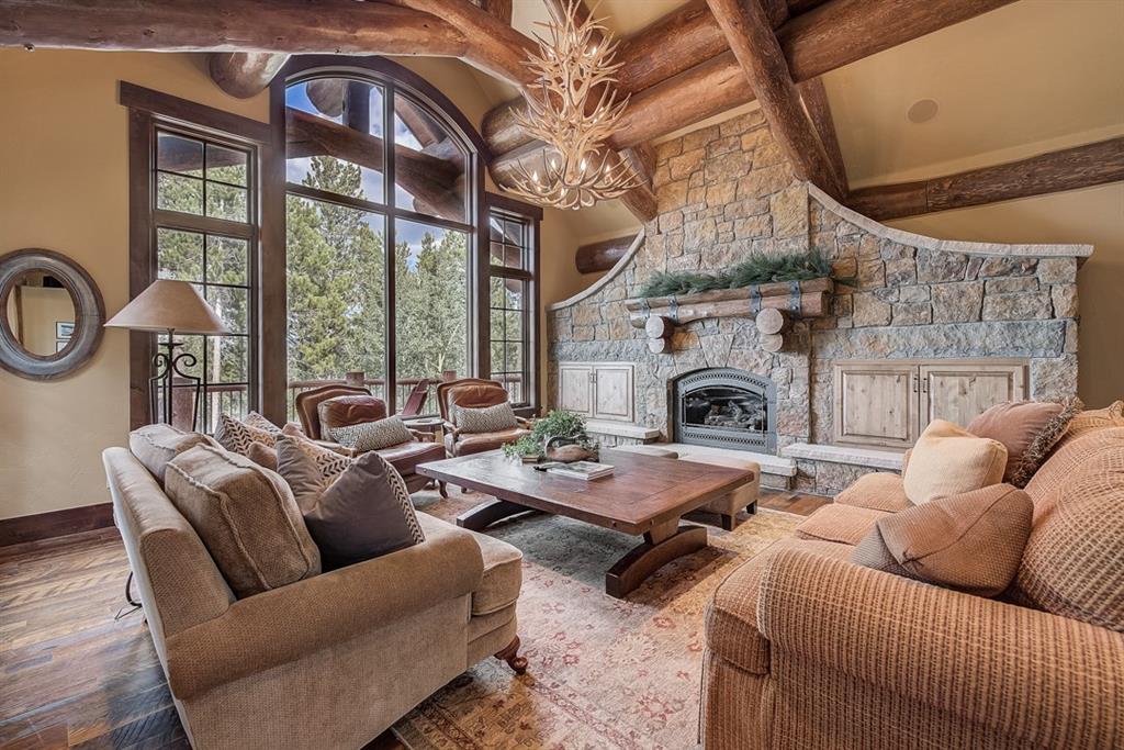 350 Timbertrail Road Breckenridge, CO 80424 - Photo 6 of 35 a living room with furniture a fireplace and a floor to ceiling window