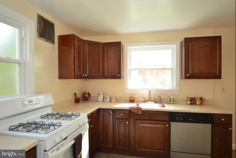 10105 Portland Place Silver Spring, MD 20901 - Photo 1 of 11 a kitchen with a sink stove top oven and cabinets