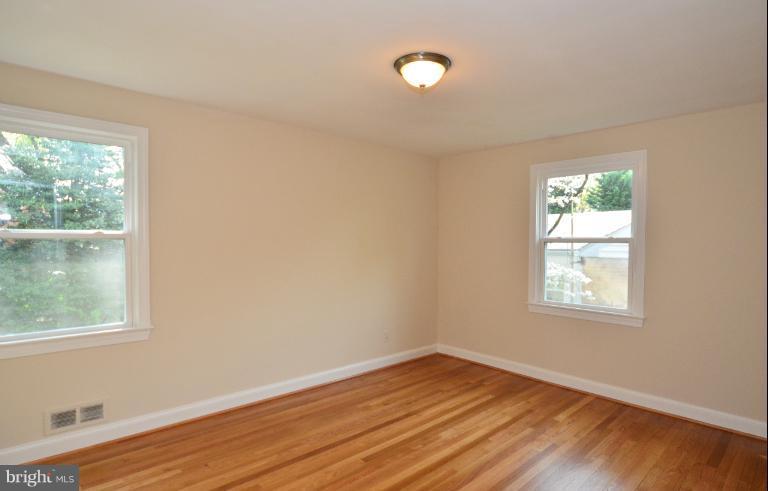 10105 Portland Place Silver Spring, MD 20901 - Photo 2 of 11 an empty room with wooden floor and windows