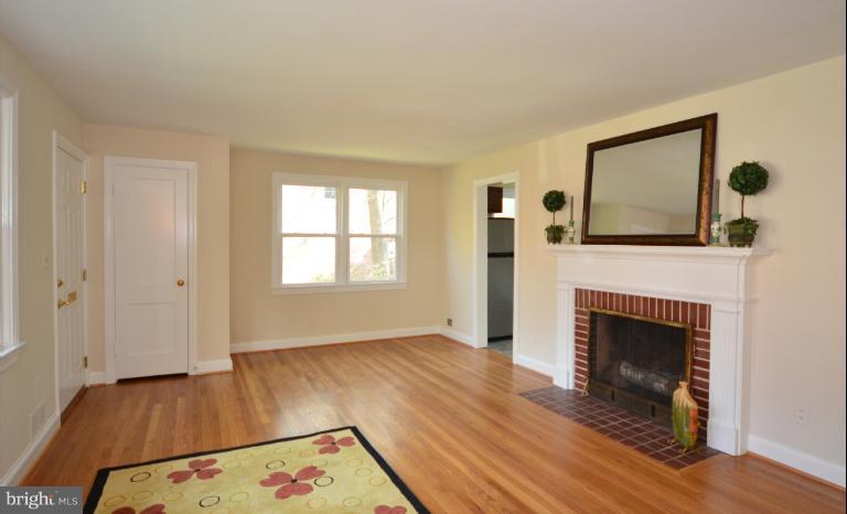 10105 Portland Place Silver Spring, MD 20901 - Photo 3 of 11 a view of a livingroom with wooden floor and a fireplace
