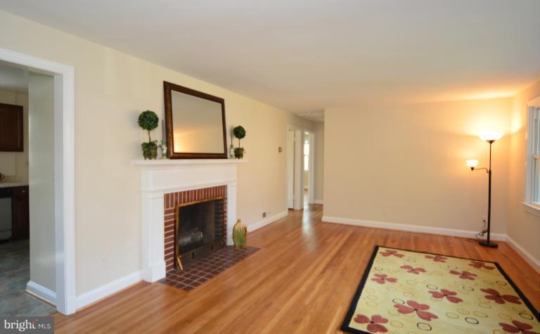 10105 Portland Place Silver Spring, MD 20901 - Photo 8 of 11 a view of an empty room with wooden floor and a fireplace