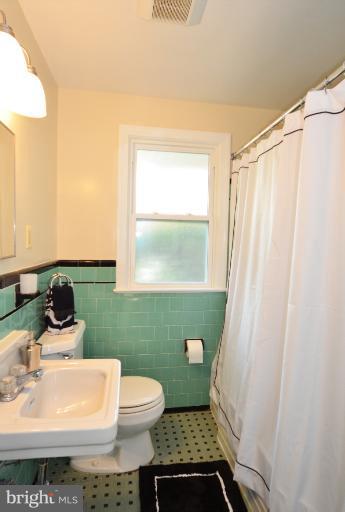 10105 Portland Place Silver Spring, MD 20901 - Photo 9 of 11 a bathroom with a sink and a mirror