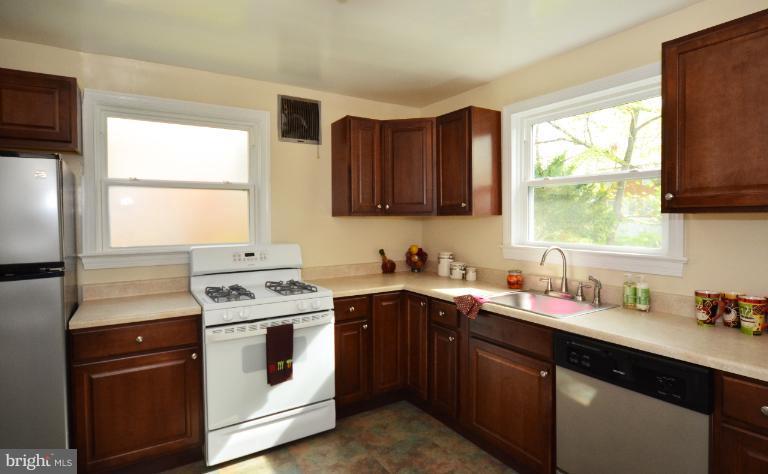 10105 Portland Place Silver Spring, MD 20901 - Photo 10 of 11 a kitchen with a sink stove top oven and refrigerator