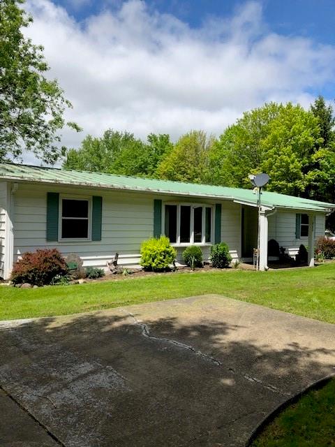 a front view of a house with a yard and porch