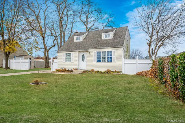 a front view of house with yard and trees