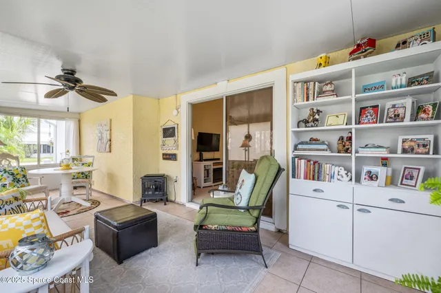 a living room with furniture and a book shelf