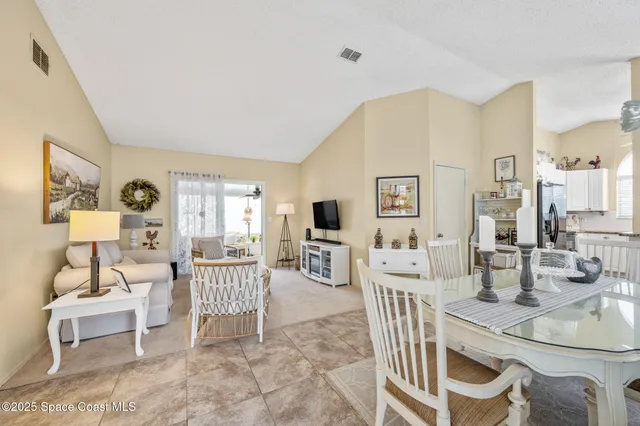a living room with furniture a flat screen tv and a table
