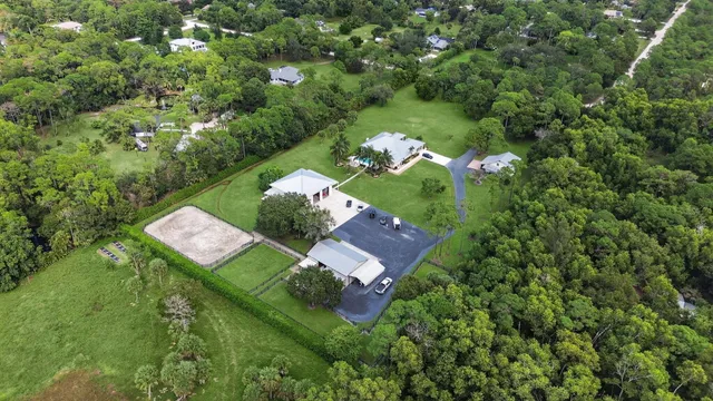 an aerial view of a house with a yard