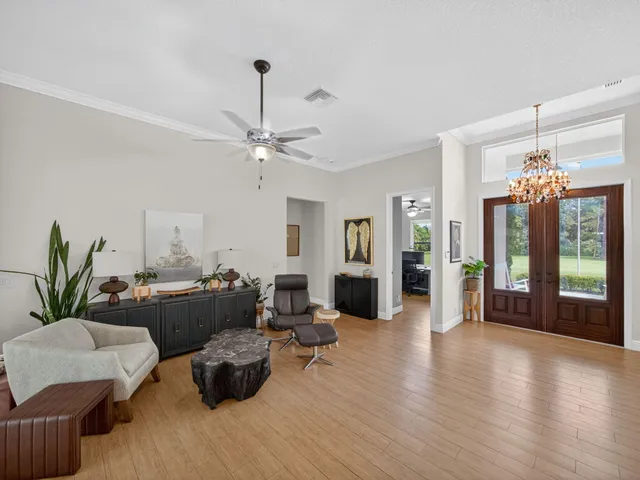 a living room with furniture and a chandelier