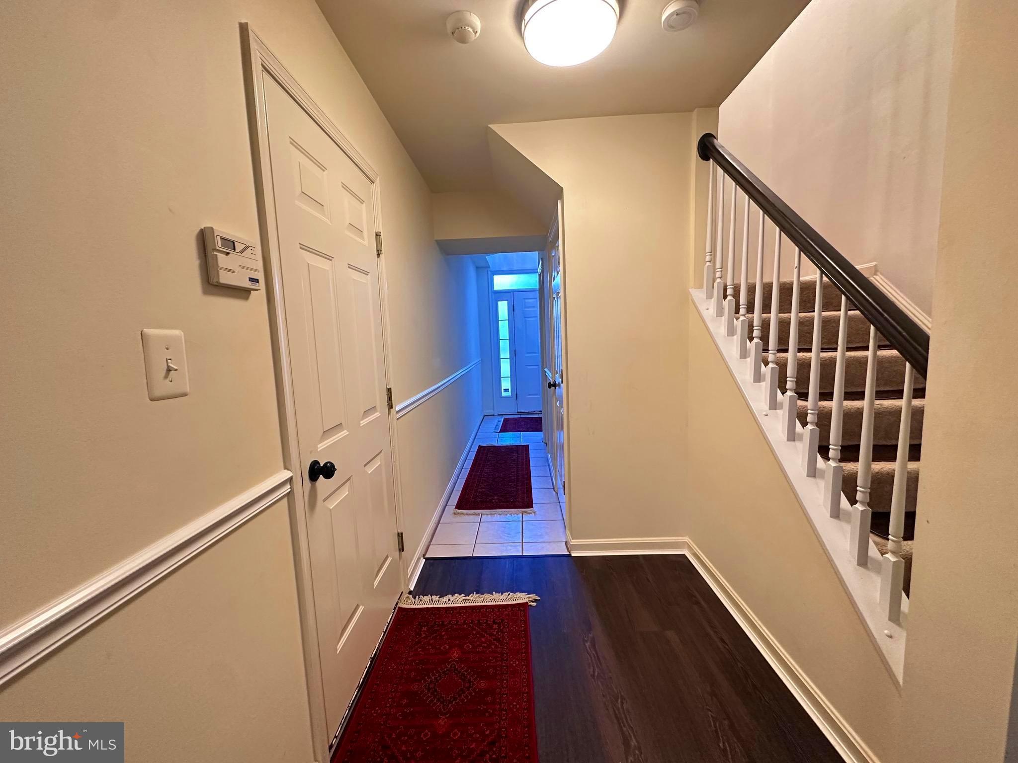 43005 Beachall Street Chantilly, VA 20152 - Photo 14 of 28 a view of a hallway with wooden floor and staircase