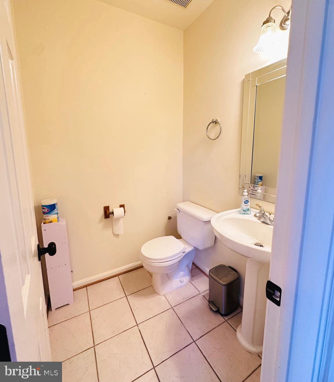 43005 Beachall Street Chantilly, VA 20152 - Photo 18 of 28 a bathroom with a granite countertop toilet a sink and a mirror