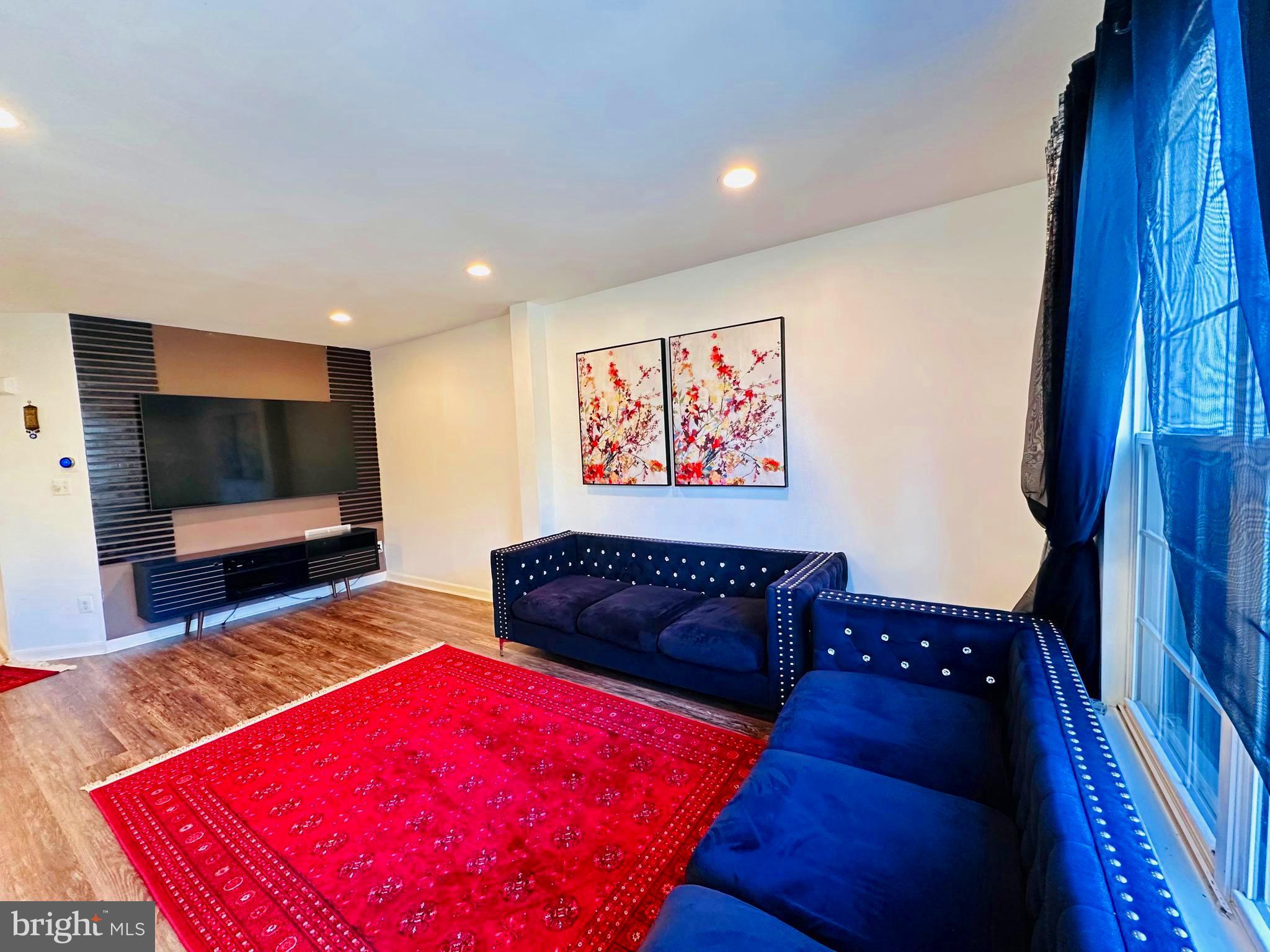 43005 Beachall Street Chantilly, VA 20152 - Photo 6 of 28 a living room with furniture a flat screen tv and a rug