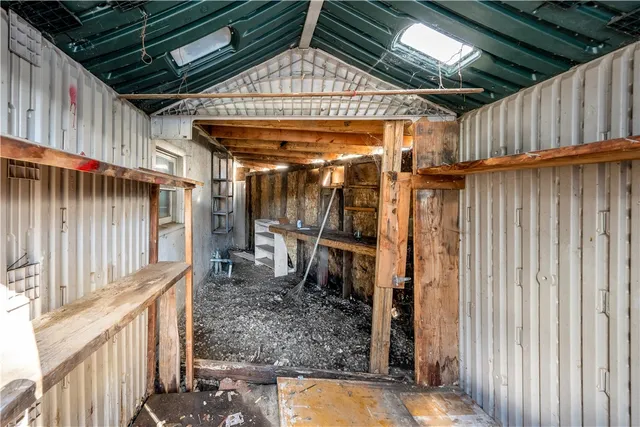 a view of water heater room with wooden floor
