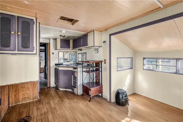 a open kitchen with stainless steel appliances granite countertop a refrigerator and microwave