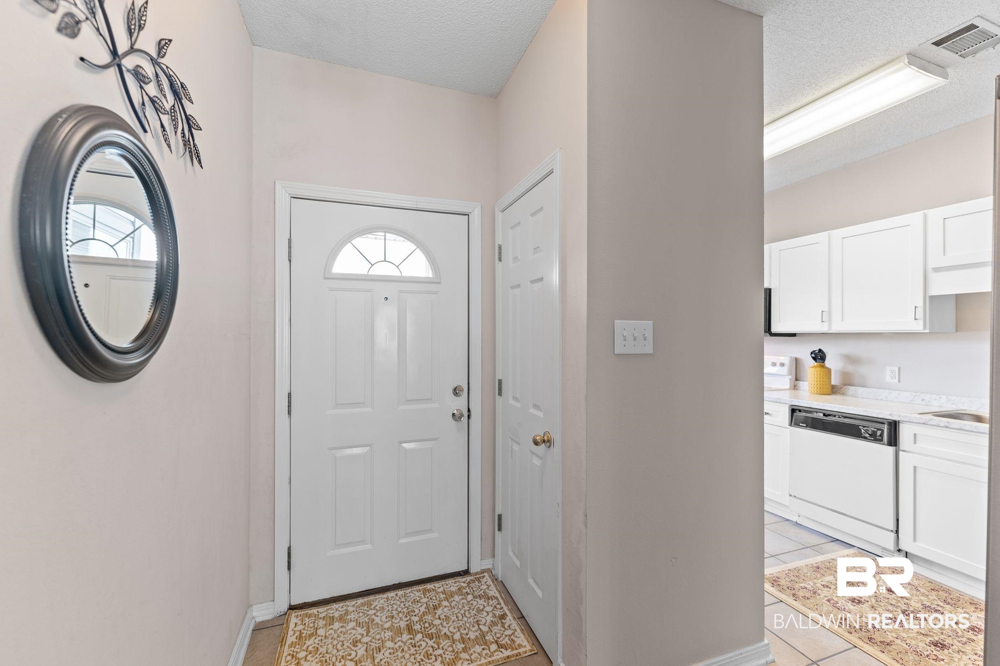 2651 South Juniper Street, Unit 203 Foley, AL 36535 - Photo 3 of 22 Entryway with a textured ceiling and light tile patterned floors