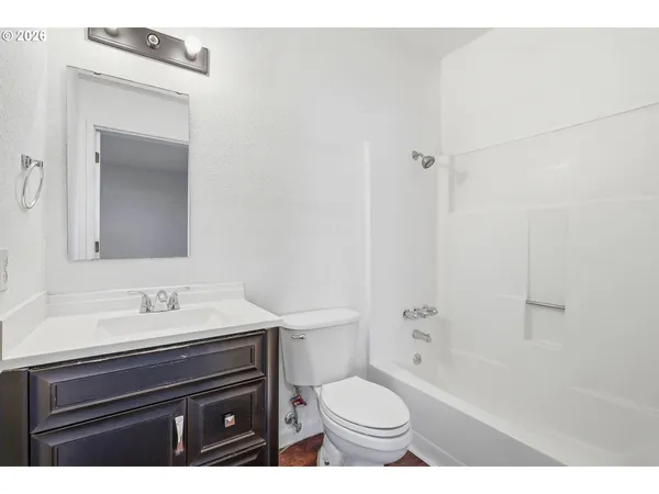 a bathroom with a sink toilet a mirror and shower