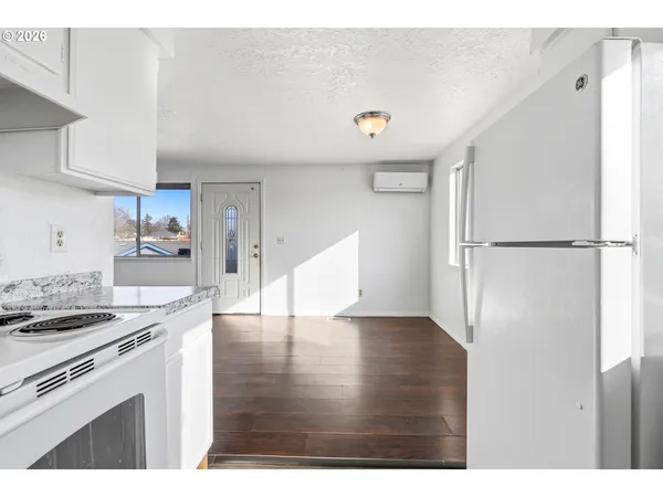 a kitchen with a refrigerator and a stove top oven