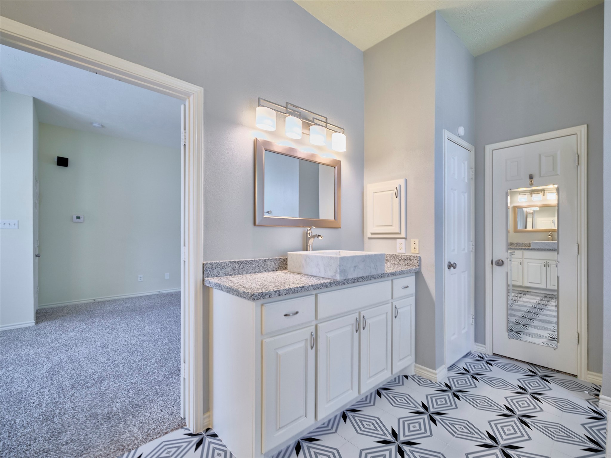 7626 Painton Lane Spring, TX 77389 - Photo 11 of 19 THE PRIMARY BATH IS COMPLETELY UPDATED WITH FUN TILE AND 2 SEPARATE SINK AREAS