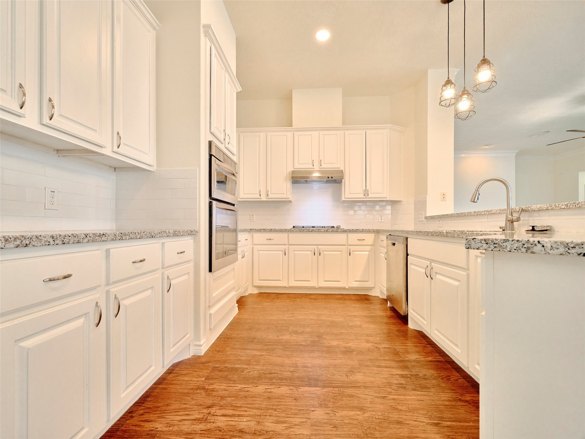 7626 Painton Lane Spring, TX 77389 - Photo 3 of 19 NEXT IS YOUR SPACIOUS KITCHEN WITH GAS STOVE, OVEN, MICROWAVE AND MODERN LIGHTING