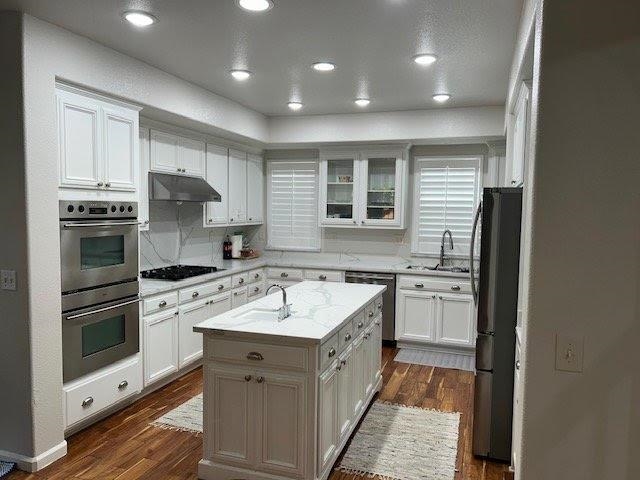 2744 Redbridge Road Tracy, CA 95377 - Photo 3 of 14 a kitchen with stainless steel appliances granite countertop a sink stove and refrigerator