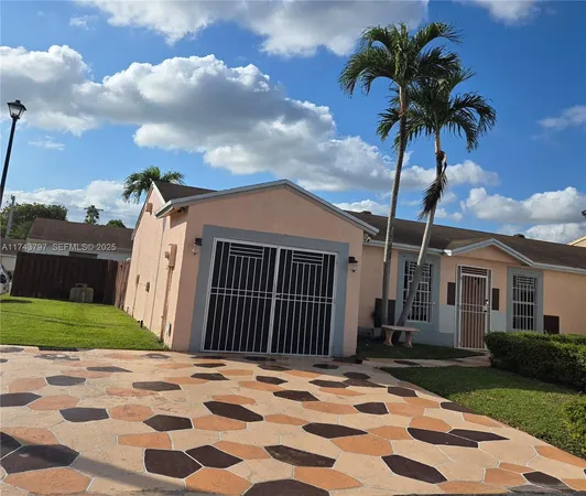 a view of a house with a yard and pathway