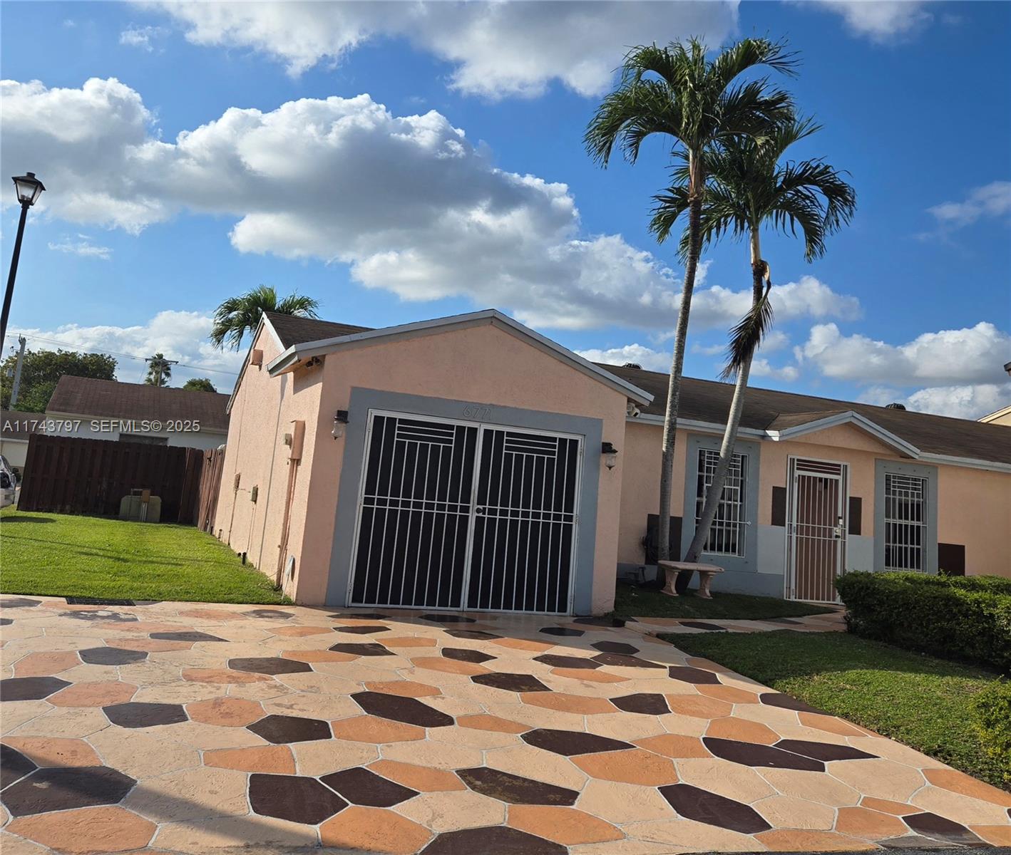 6771 Northwest 199th Terrace Hialeah, FL 33015 - Photo 1 of 42 a view of a house with a yard and pathway