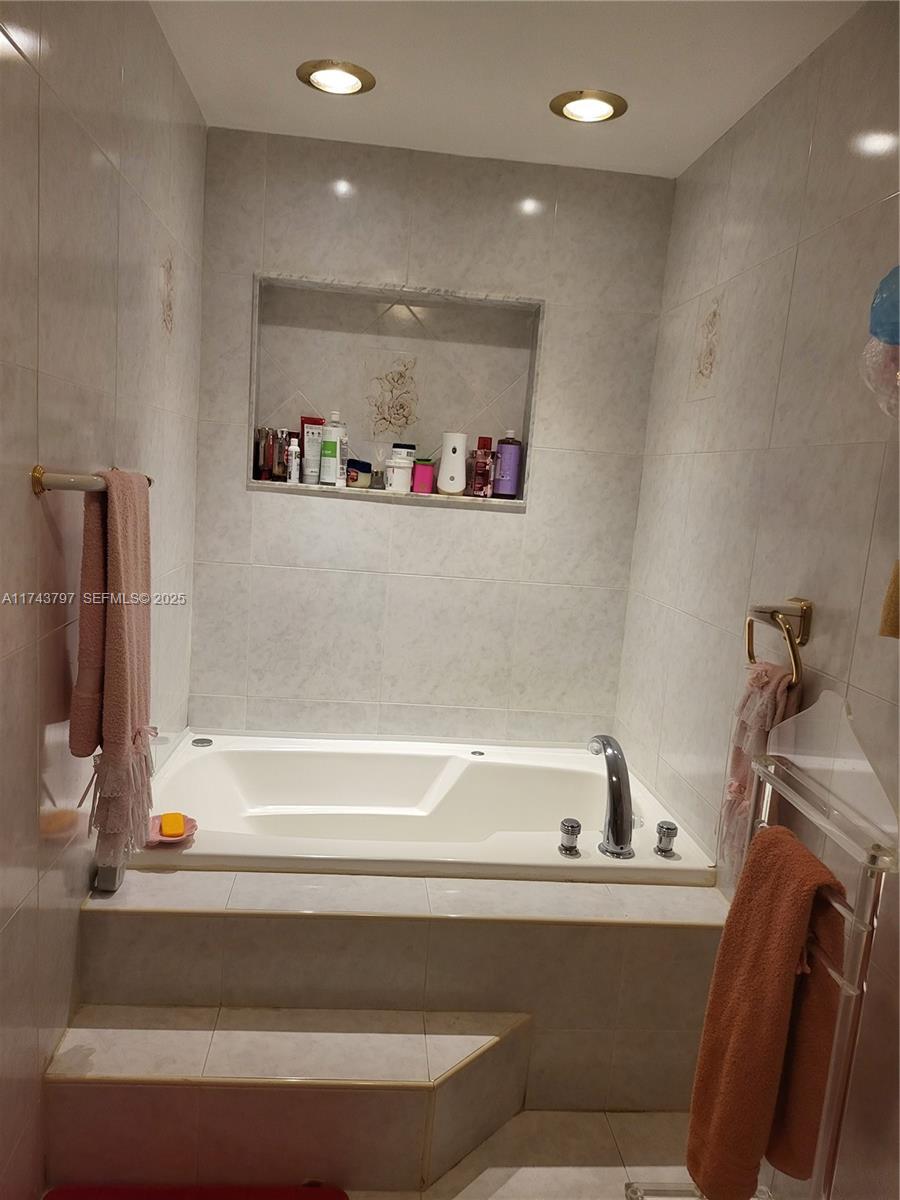 6771 Northwest 199th Terrace Hialeah, FL 33015 - Photo 11 of 42 a bathroom with a bathtub and a sink