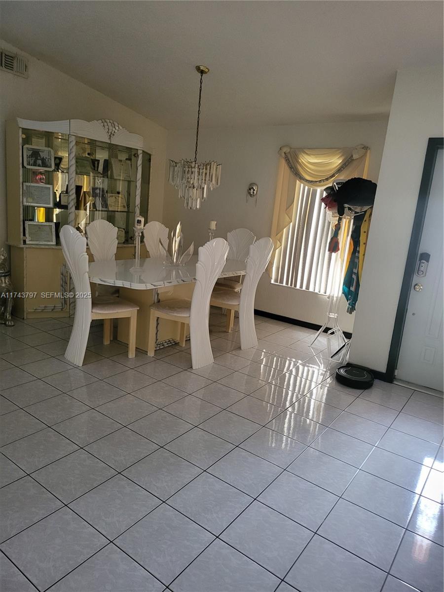 6771 Northwest 199th Terrace Hialeah, FL 33015 - Photo 12 of 42 a view of a dining room with furniture