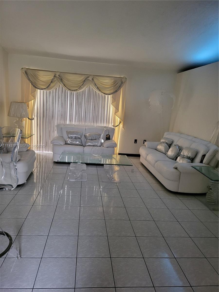 6771 Northwest 199th Terrace Hialeah, FL 33015 - Photo 13 of 42 a living room with furniture and a couch