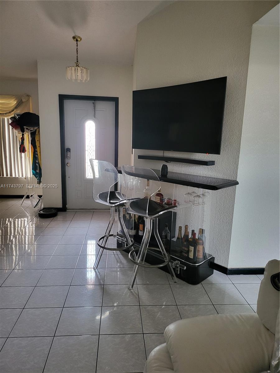 6771 Northwest 199th Terrace Hialeah, FL 33015 - Photo 14 of 42 a living room with furniture and a flat screen tv