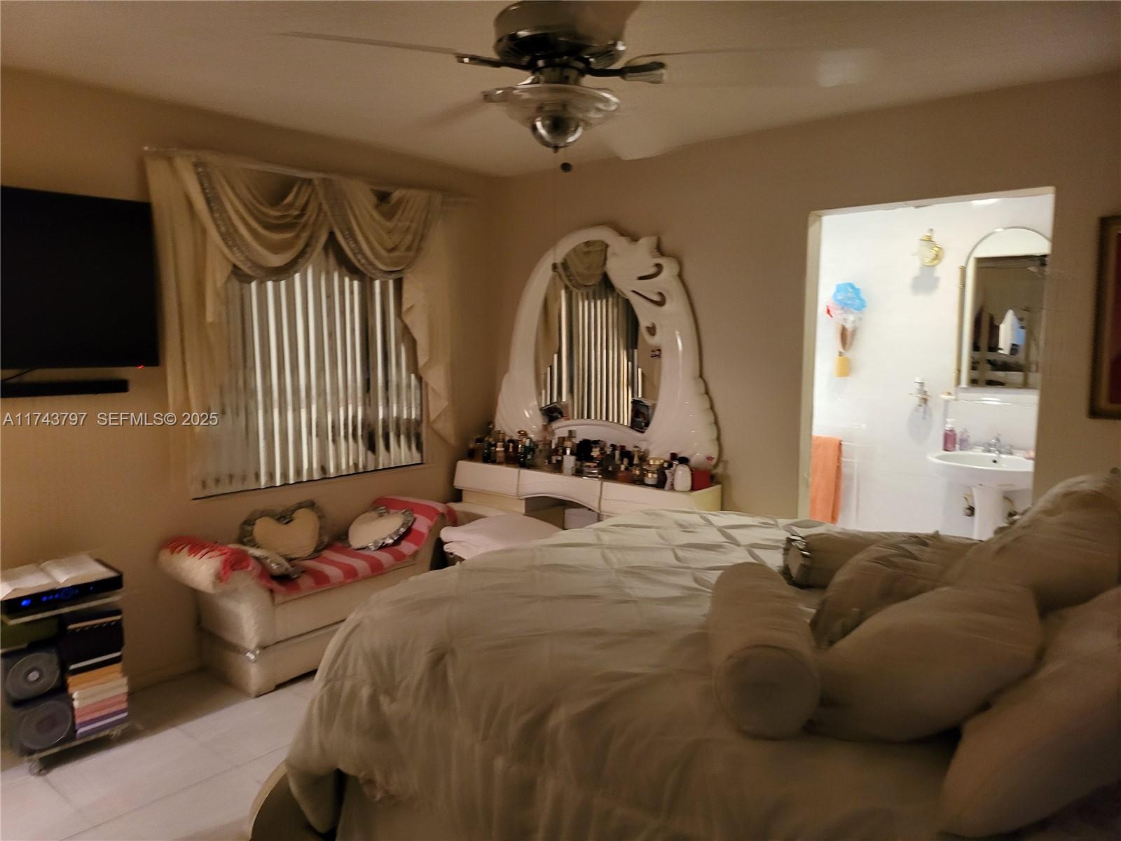 6771 Northwest 199th Terrace Hialeah, FL 33015 - Photo 16 of 42 a bed room with a bed and a television