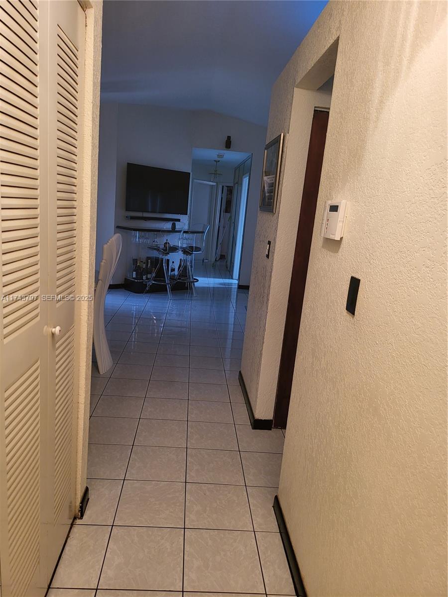 6771 Northwest 199th Terrace Hialeah, FL 33015 - Photo 17 of 42 a view of a livingroom with furniture and a flat screen tv
